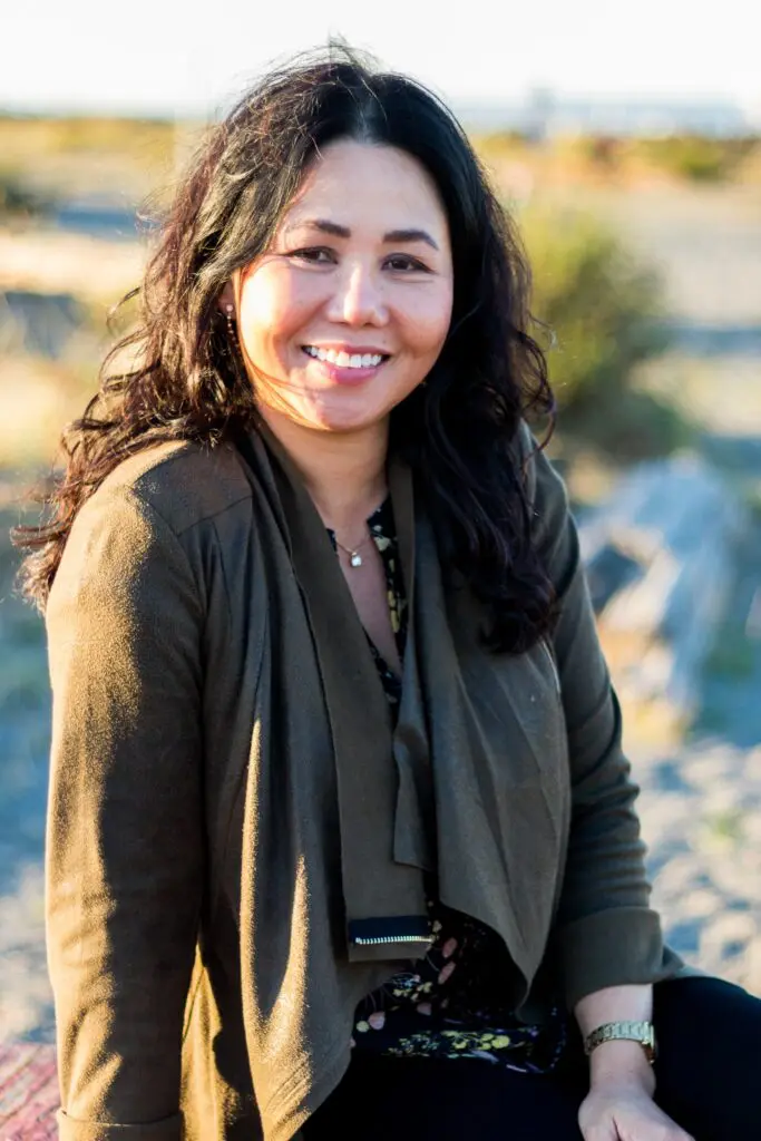 Binh Profile picture (1) Binh Herdrick smiling outdoors, radiating warmth and resilience.
